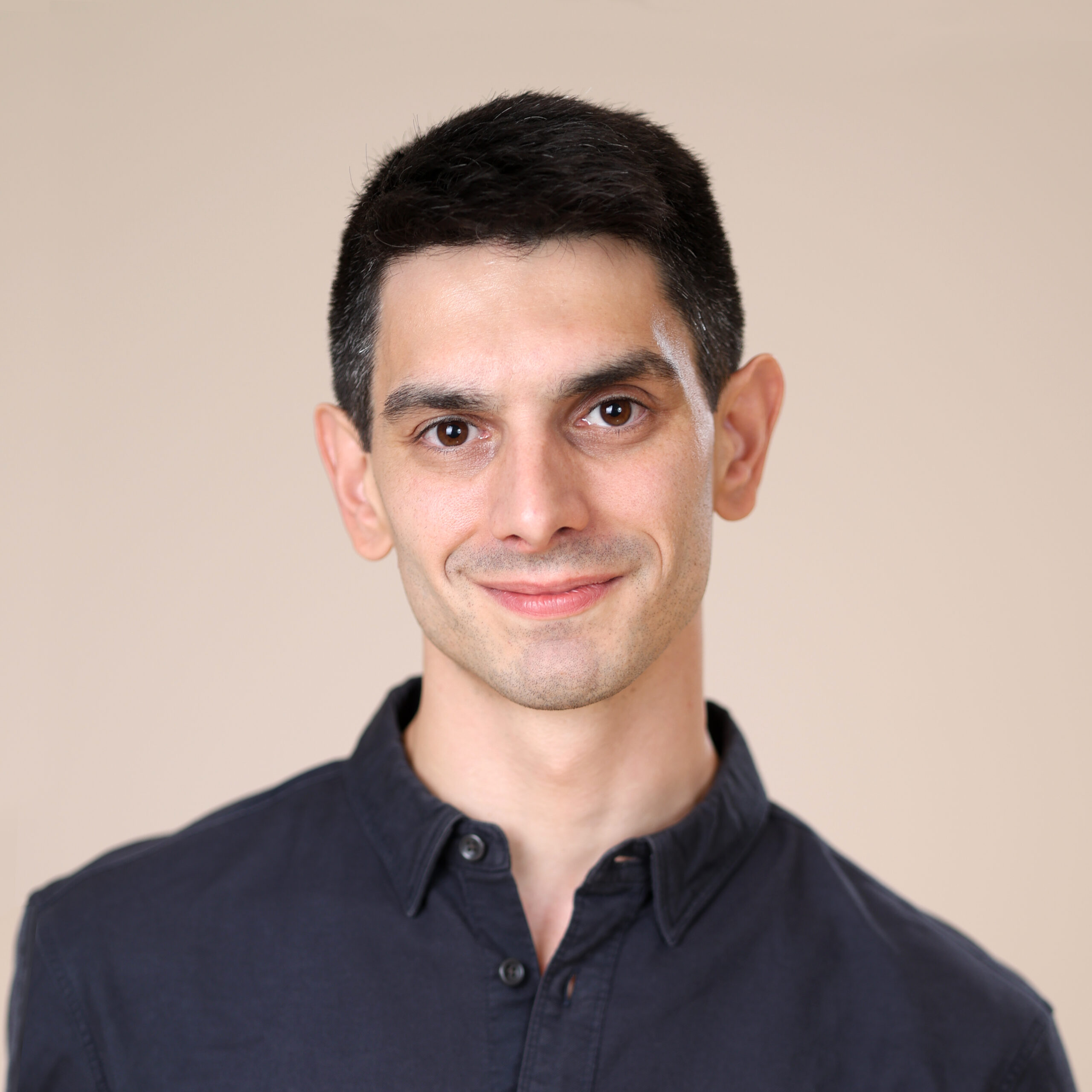 A professional headshot portrait of Frank Ball. The image features a clear, medium-close up of his face with a friendly yet confident expression. He is wearing formal attire, and the background is simple and neutral to keep the focus on his features.