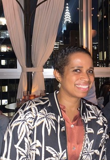 A professional headshot portrait of Vonetta DeVonish. The image shows a medium-close up of her face, smiling and looking directly at the camera. She is dressed in business attire and photographed against a clean, neutral background that emphasizes her features.