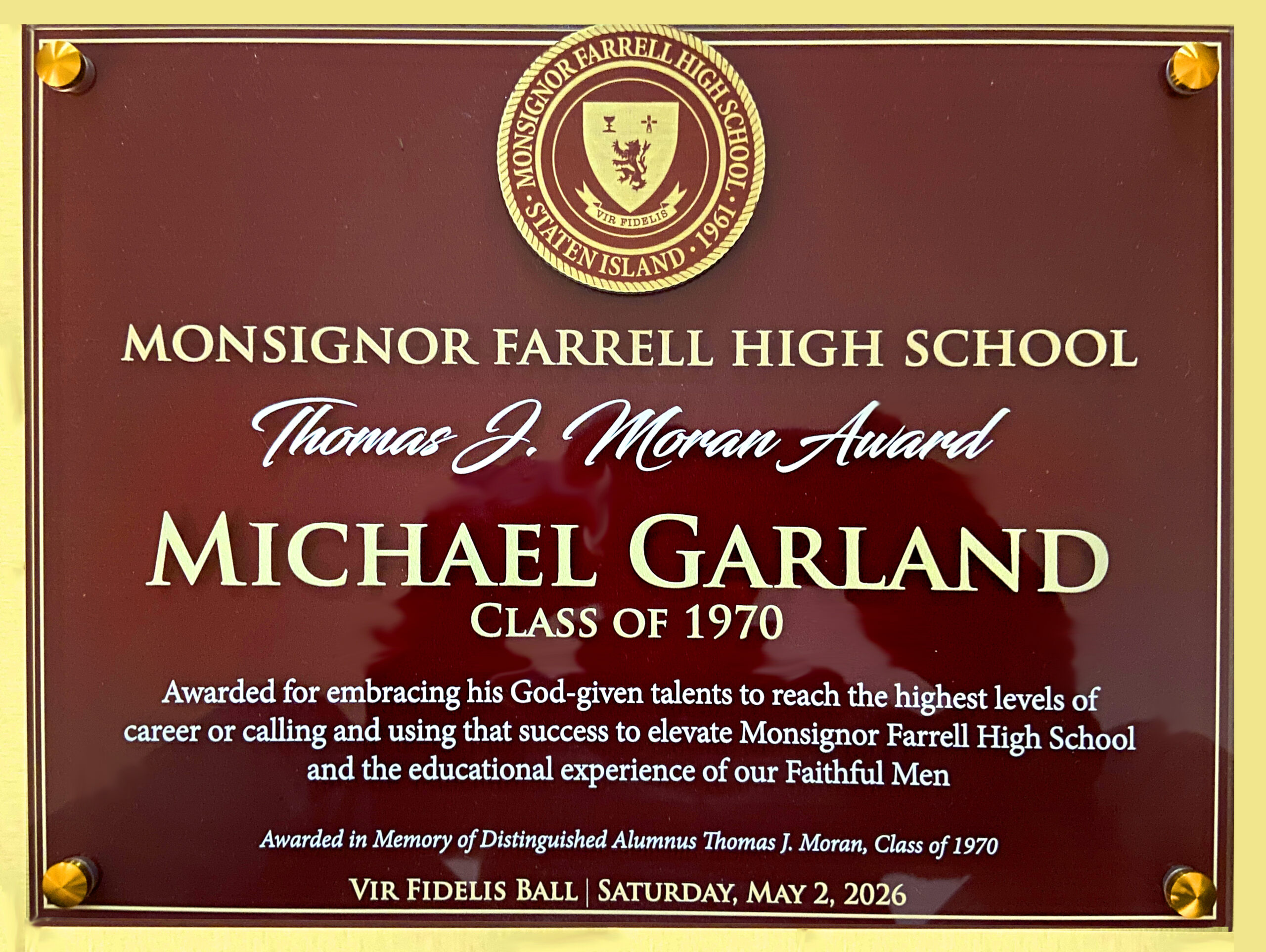 Award reads Monsignor Farrell High School Thomas J. Moran Award Michael Garland Class of 1970 Awarded for embracing his God-given talents to reach the highest levels of career or calling and using that success to elevate Monsignor Farrell High School and the educational experience of our Faithful Men