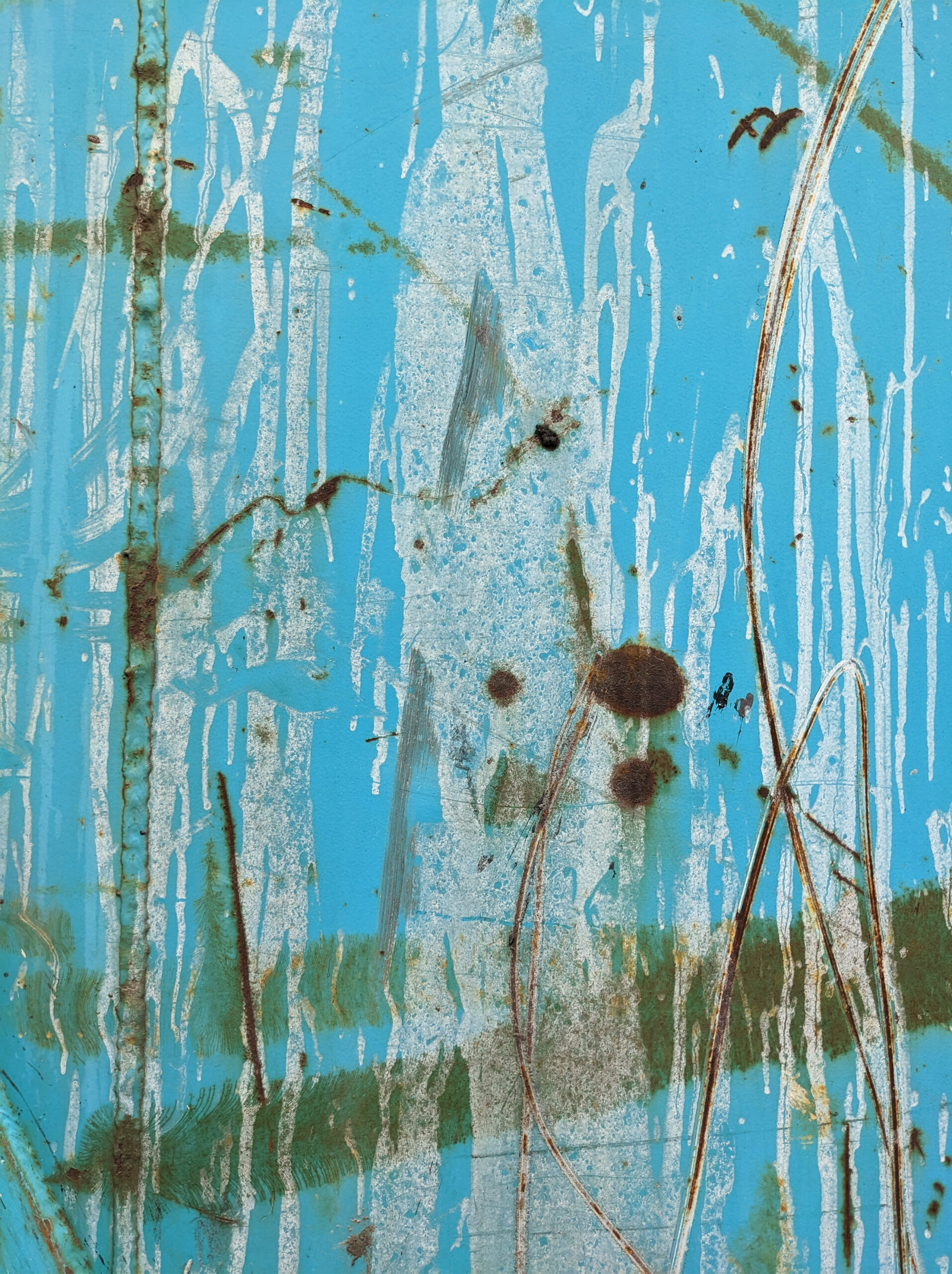 A blue surface with streaks of white and green with brown dots