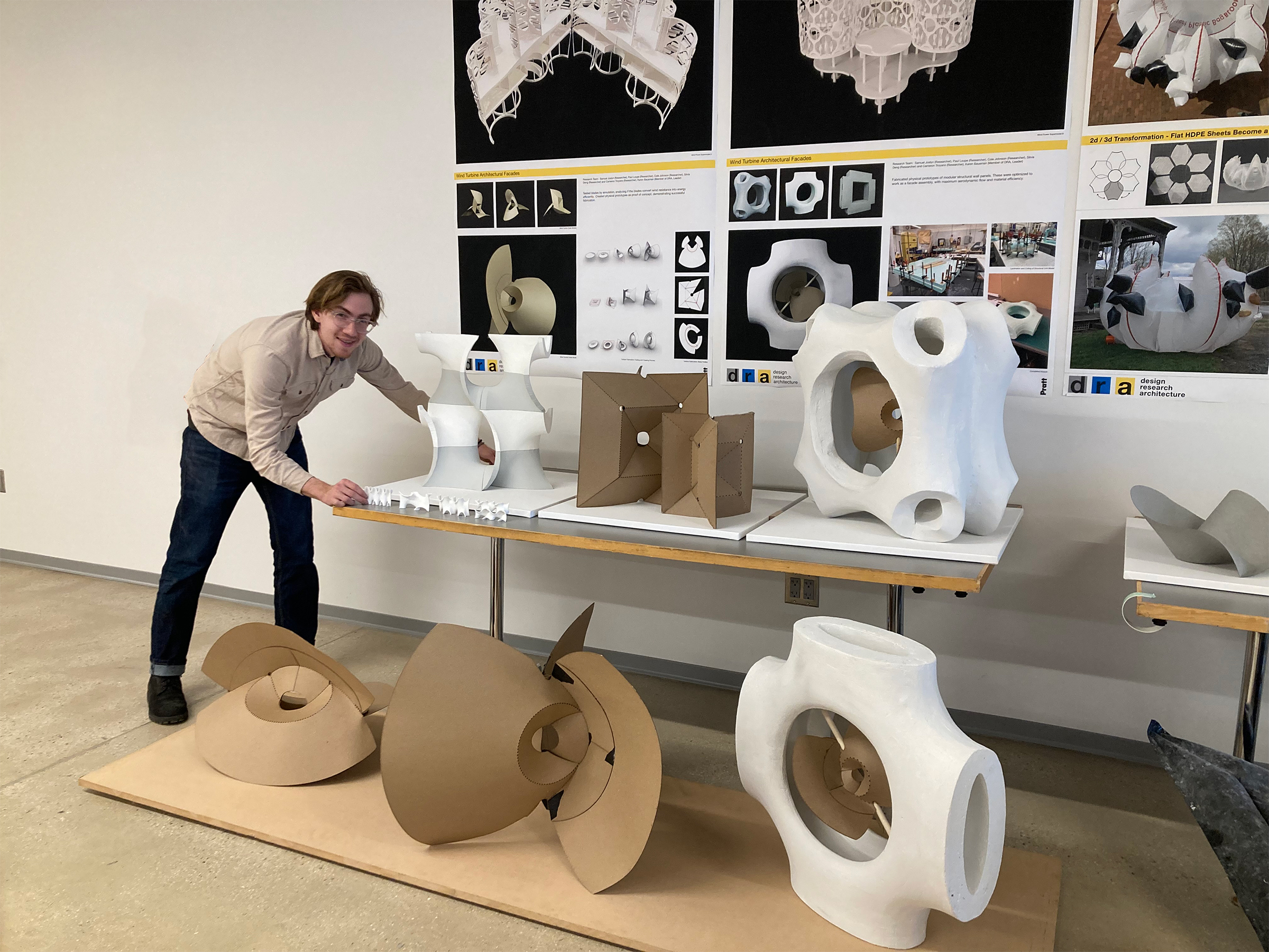 Paul Loupe stands next to a display of his designs.