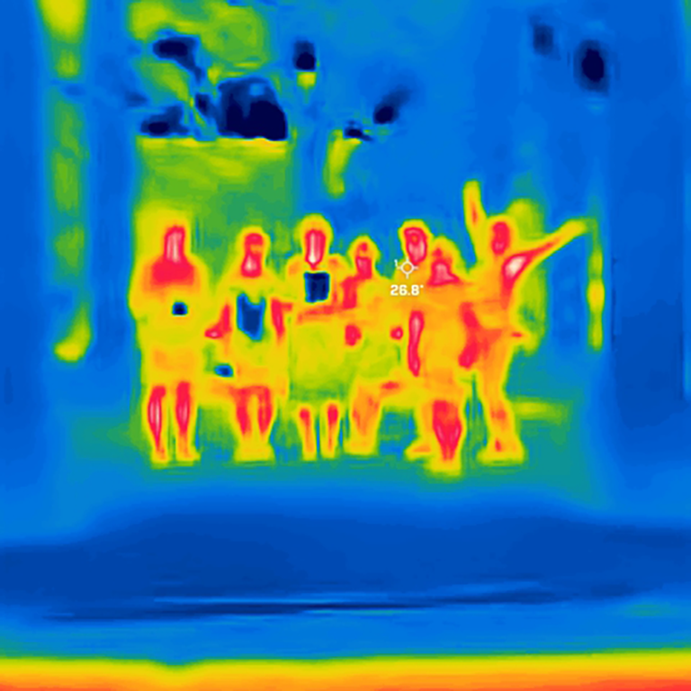 a thermo heat scan colored green, blue, yellow and orange of 7 people