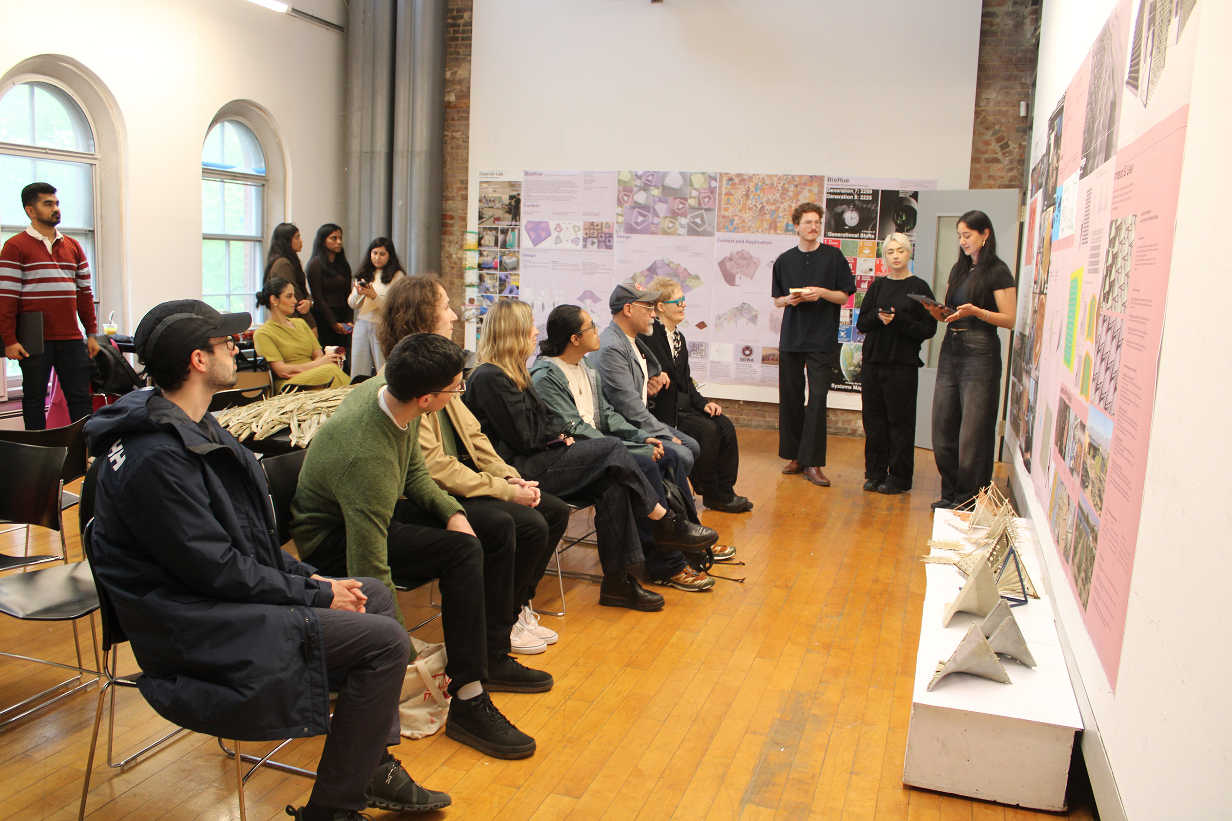 Architecture students present project in front of a class.