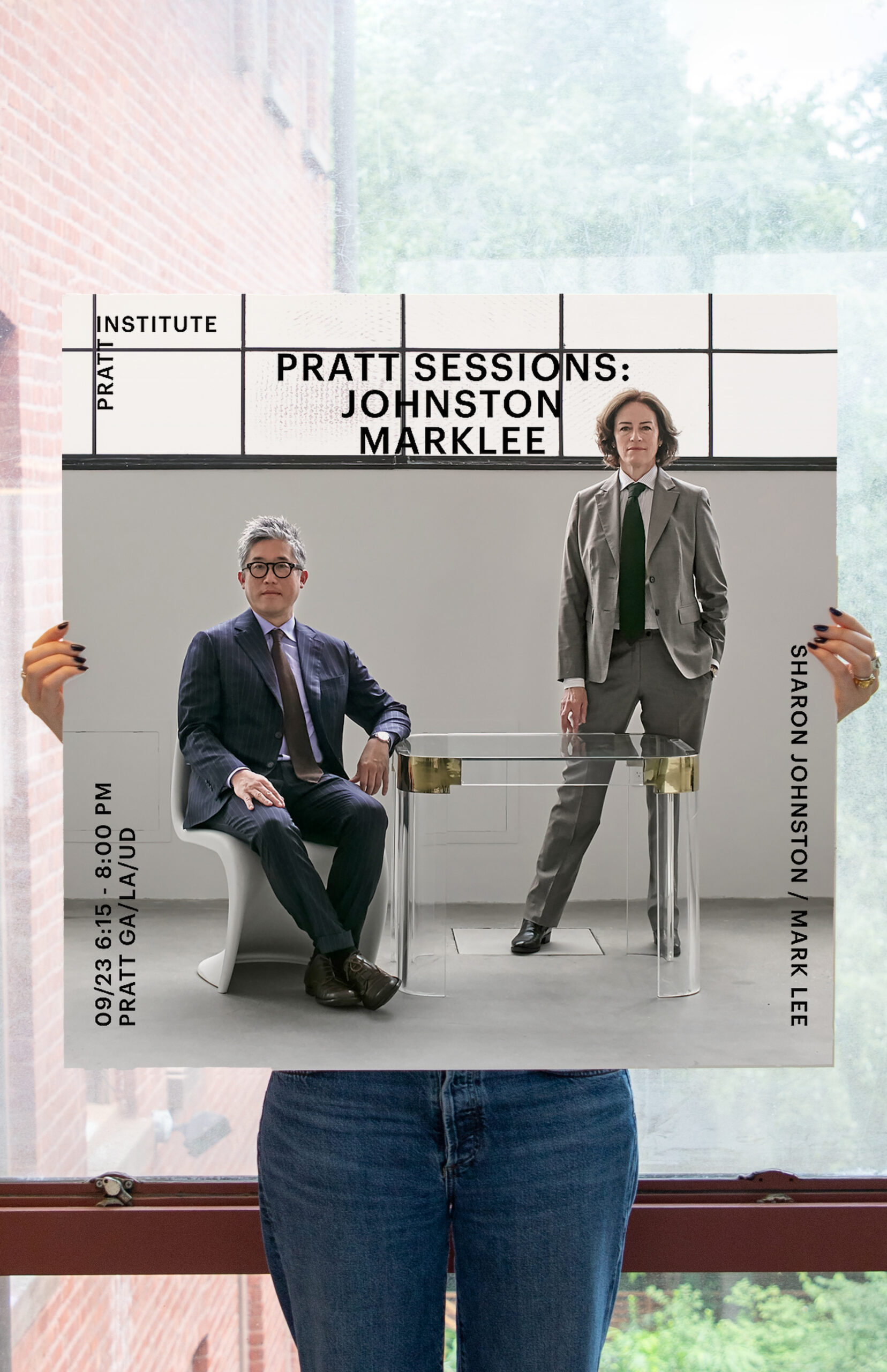 Close-up of the “Pratt Sessions: Johnston Marklee” poster held by a person. The design shows two people in suits positioned around a clear glass table, with event details and names displayed in minimalist black typography.
