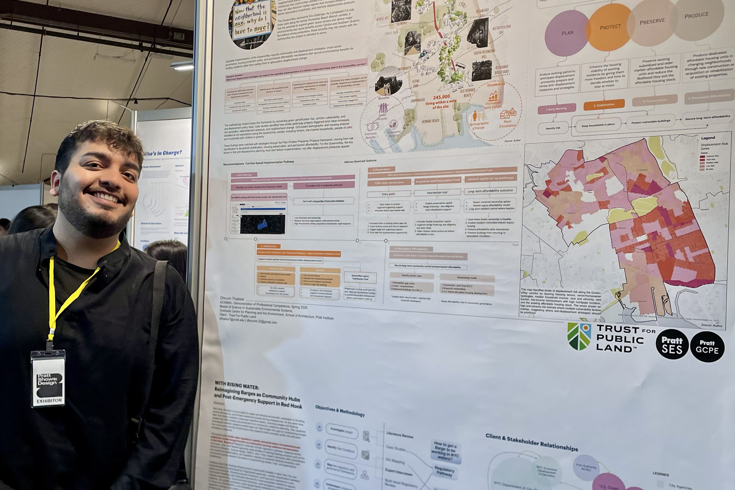 A smiling student standing in front of their research poster.
