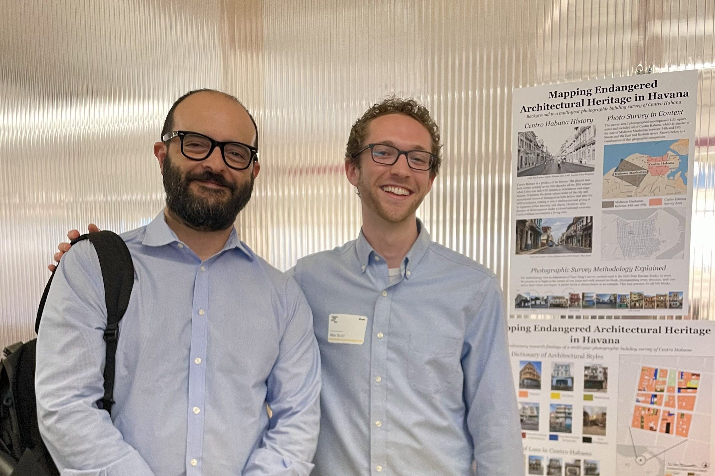 A faculty member and students standing in front of the student’s research posters.