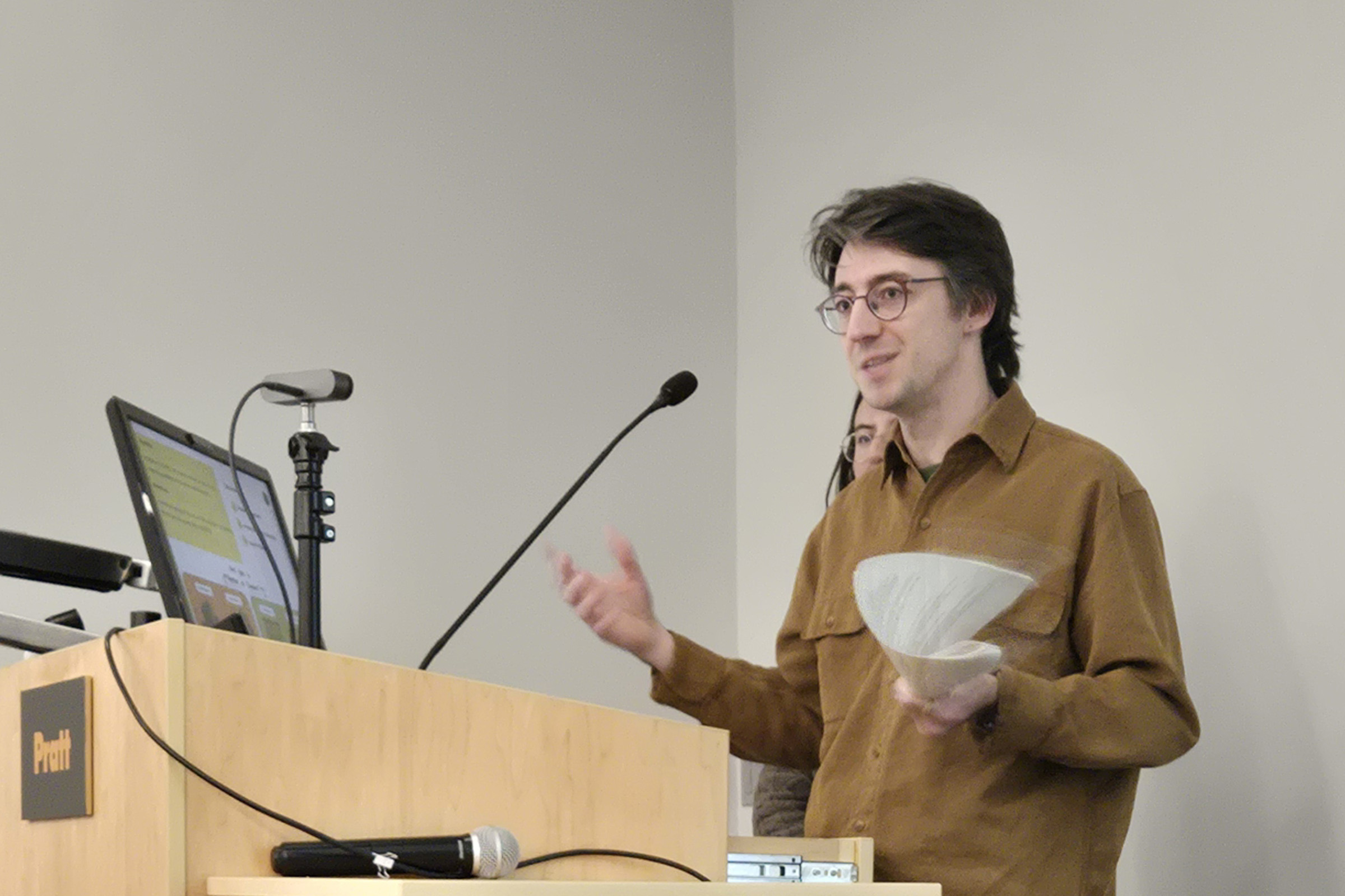 A student presenting research findings from a studio course.