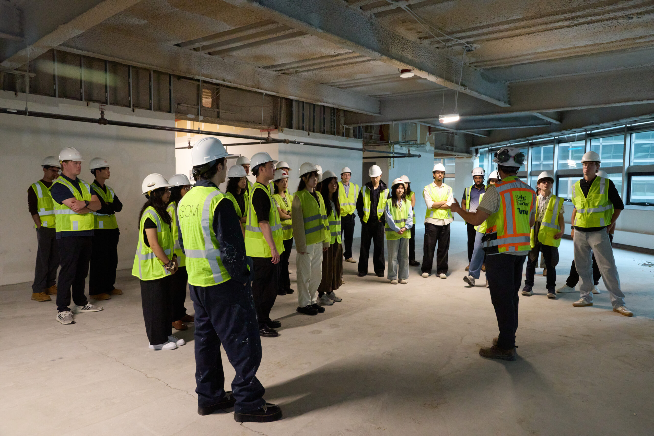 Group of construction workers inside of a building.