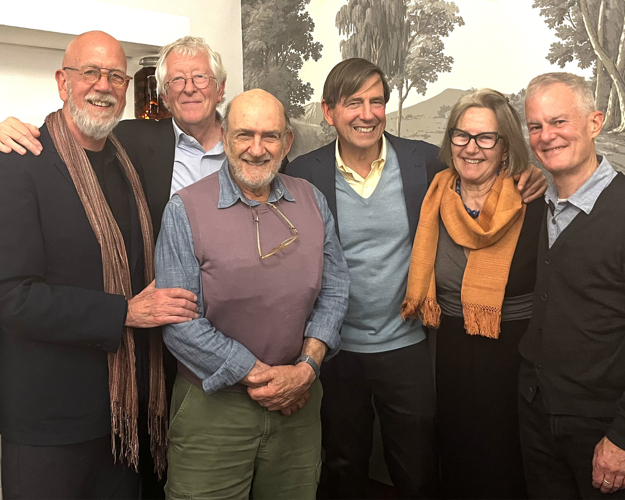 A group of six people smiling and posing.
