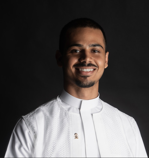 Portrait of a young man against a black background.