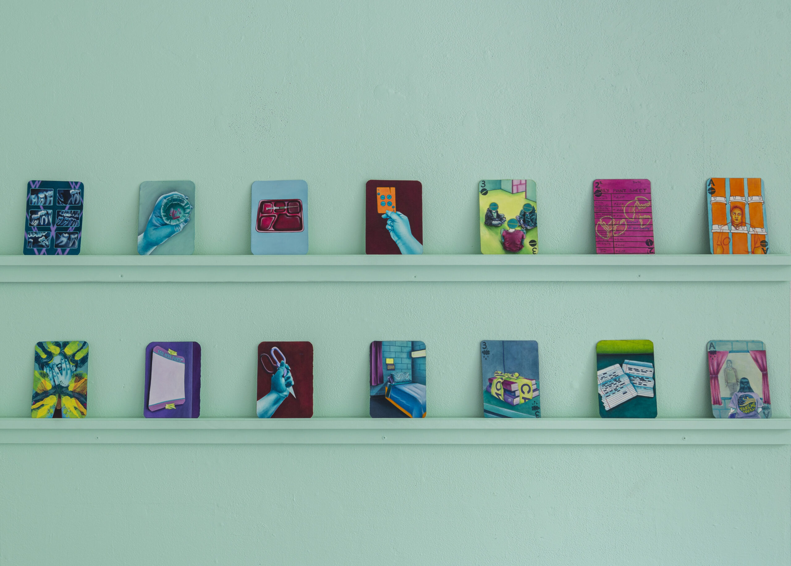 a collection of images, positioned on two shelves, evenly spaced