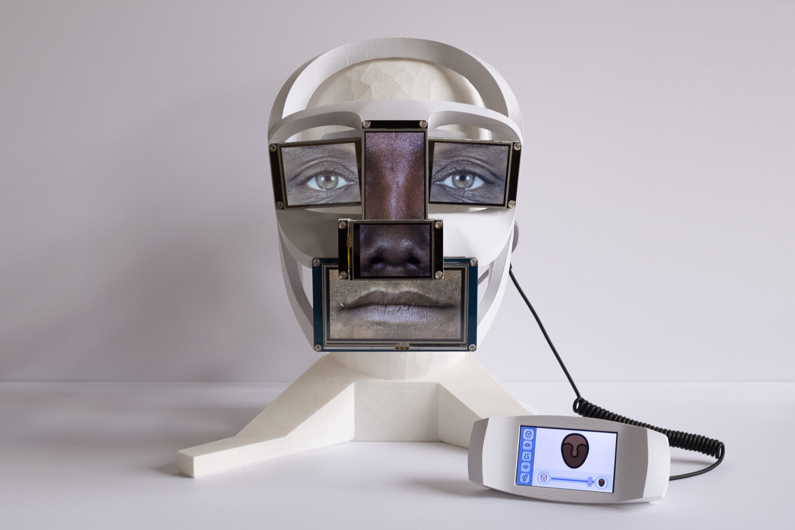 Work by John Wright using mixed media of a mannequin face with screens over the eyes
