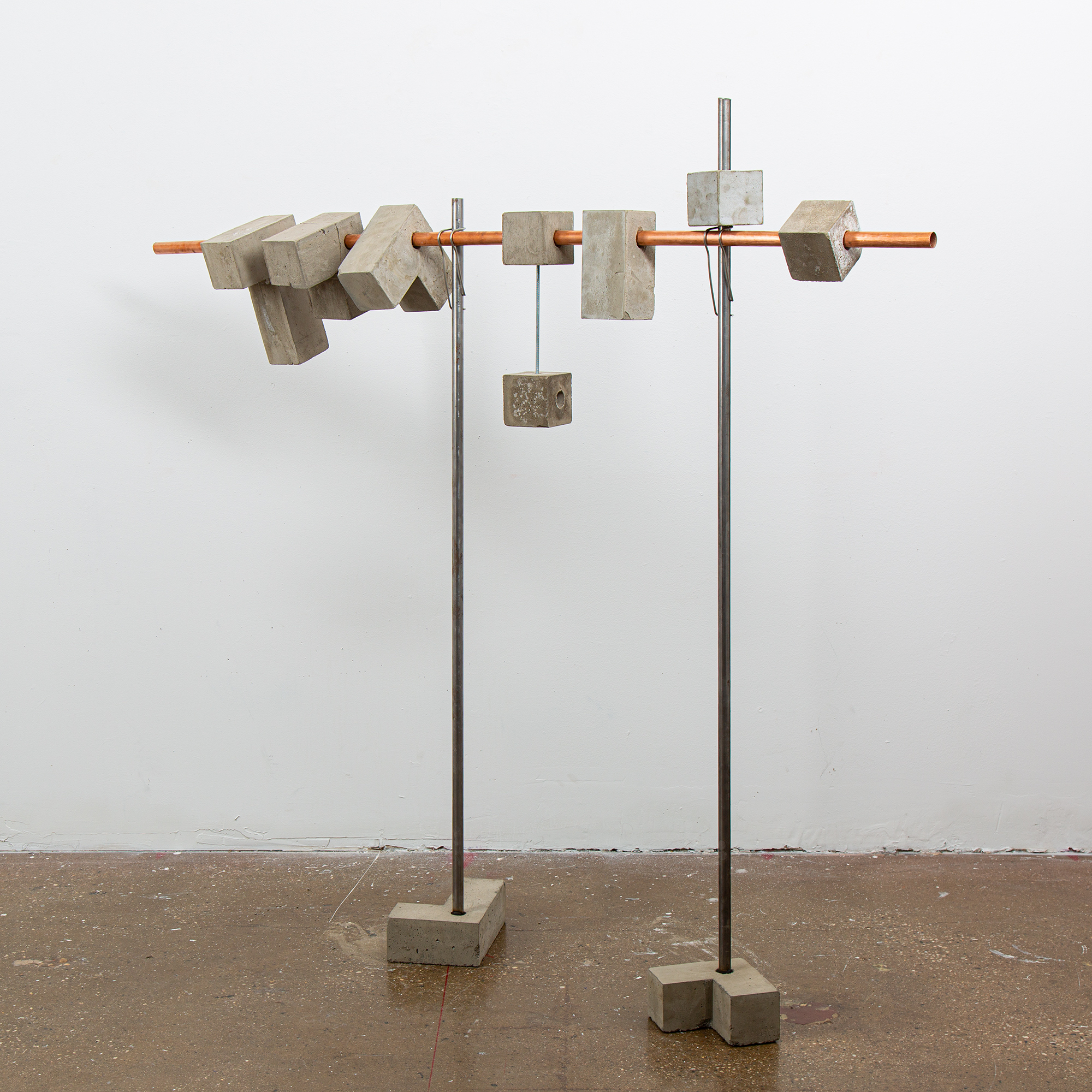 installation consisting of thin metal bars, with concrete blocks at each end