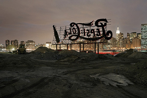 Photo of a derelict Coca Cola sign in a post-industrial wasteland.