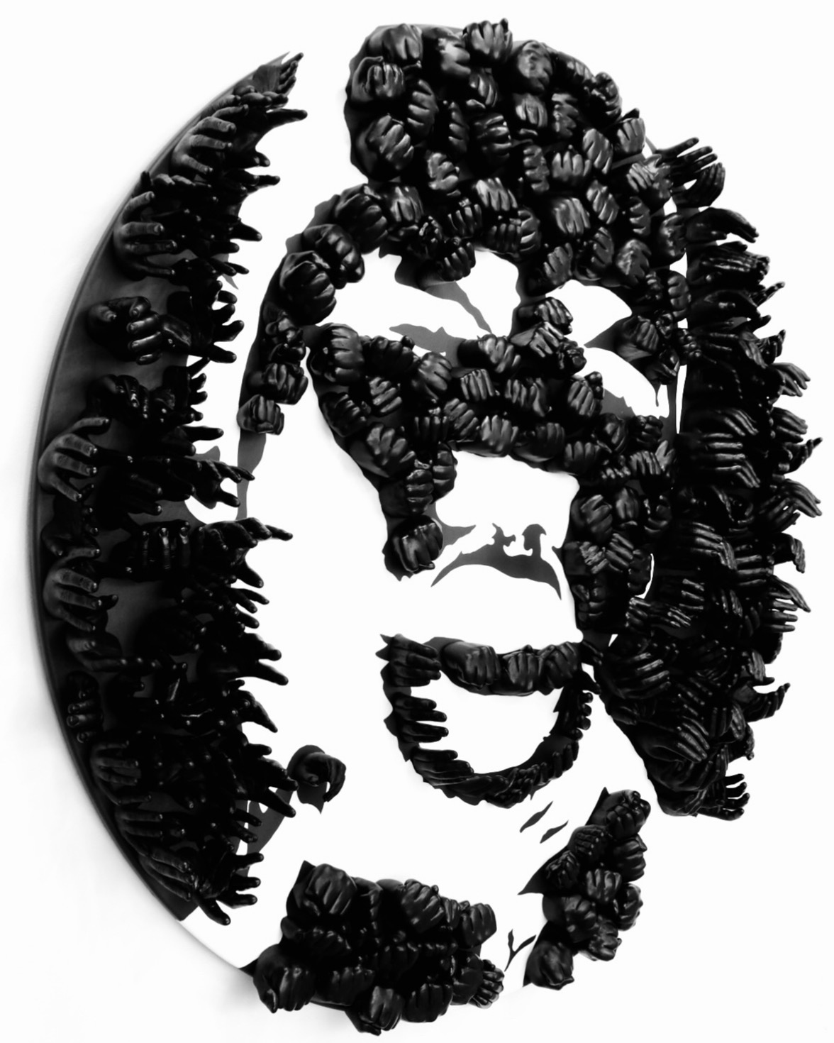 An oval shaped sculpture of an abstract face. The sculpture is made up of little black hands in different formations jutting out from the sculpture's mount.
