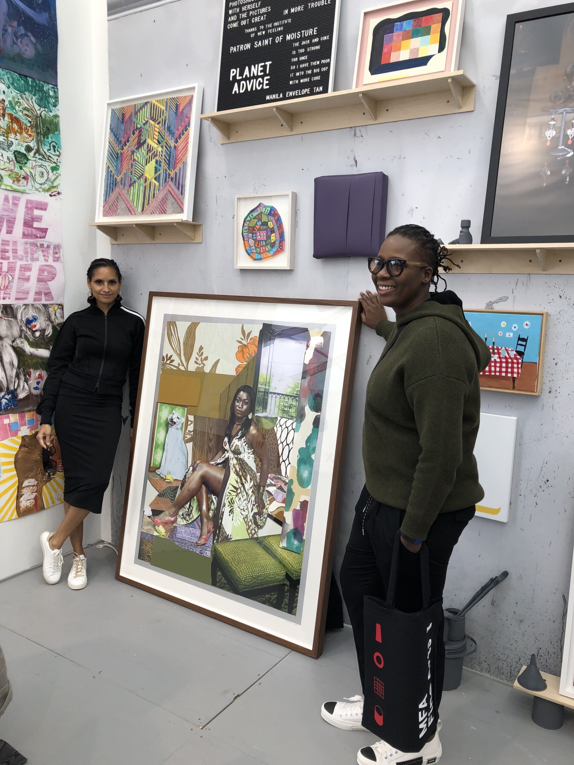 two students standing with art piece