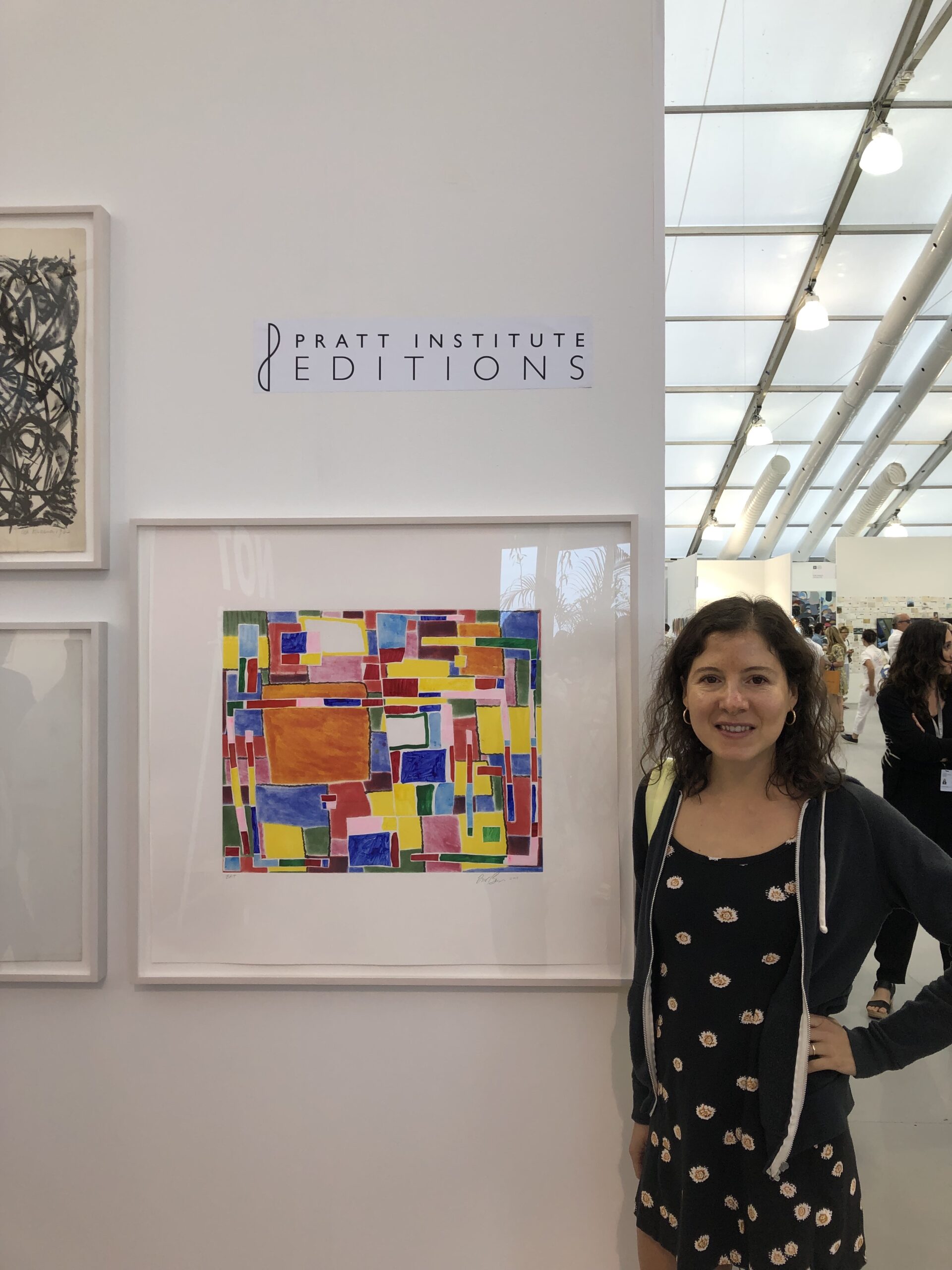 student standing with art piece