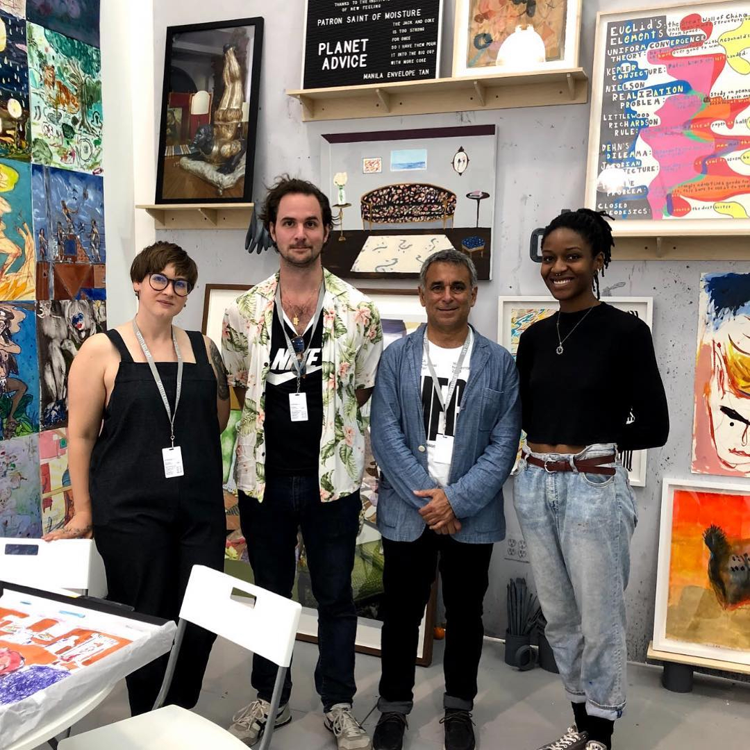 students gathered together in art studio, smiling