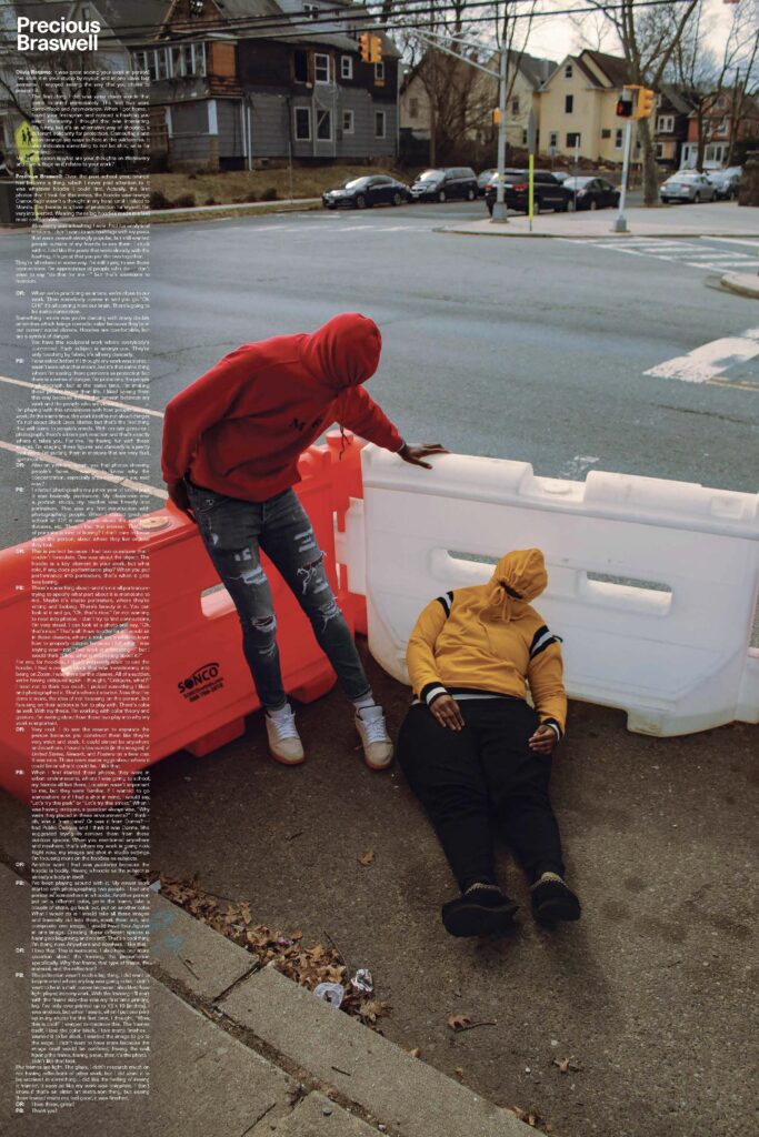 Photo of two people sprawled on traffic plastic dividers of orange and white colors.