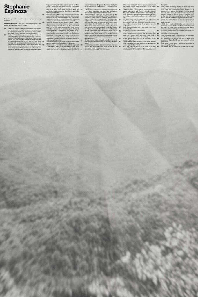 Black and white photo of rolling hills with green grass and a light fog