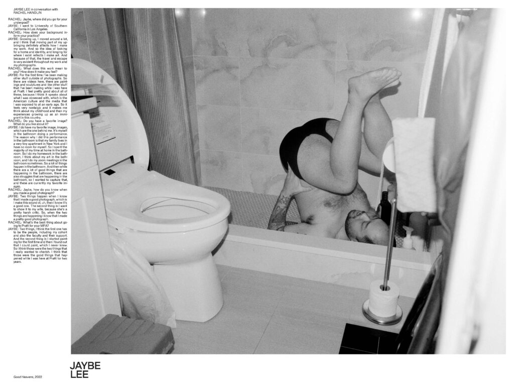 A black and white phot of a man tumbling onto a bath tup while wearing black underwear