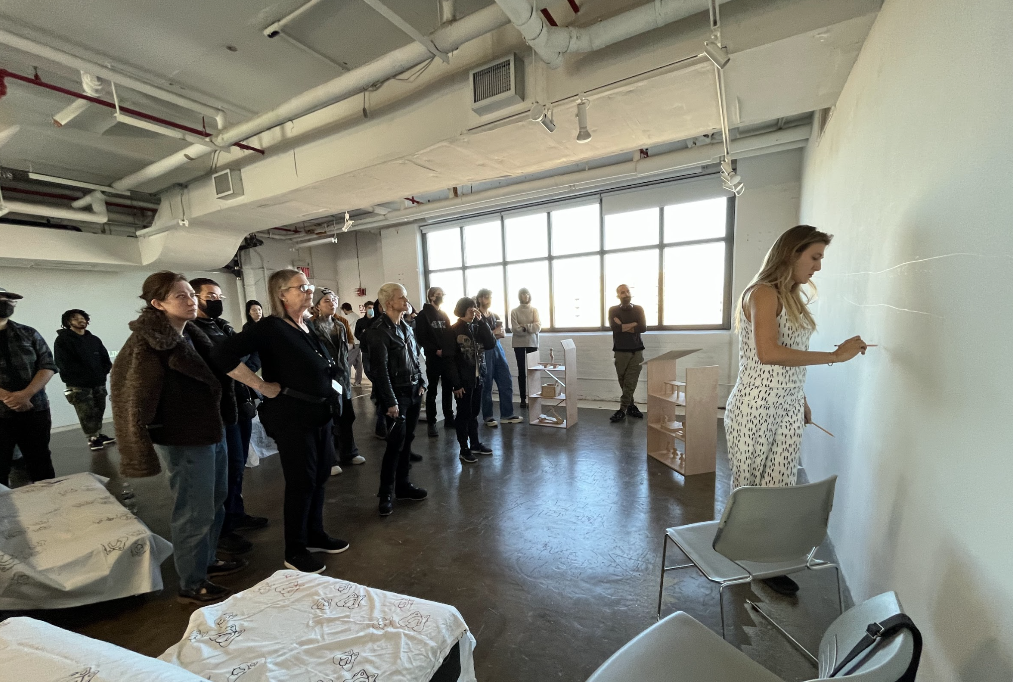 students speaking with teacher in classroom