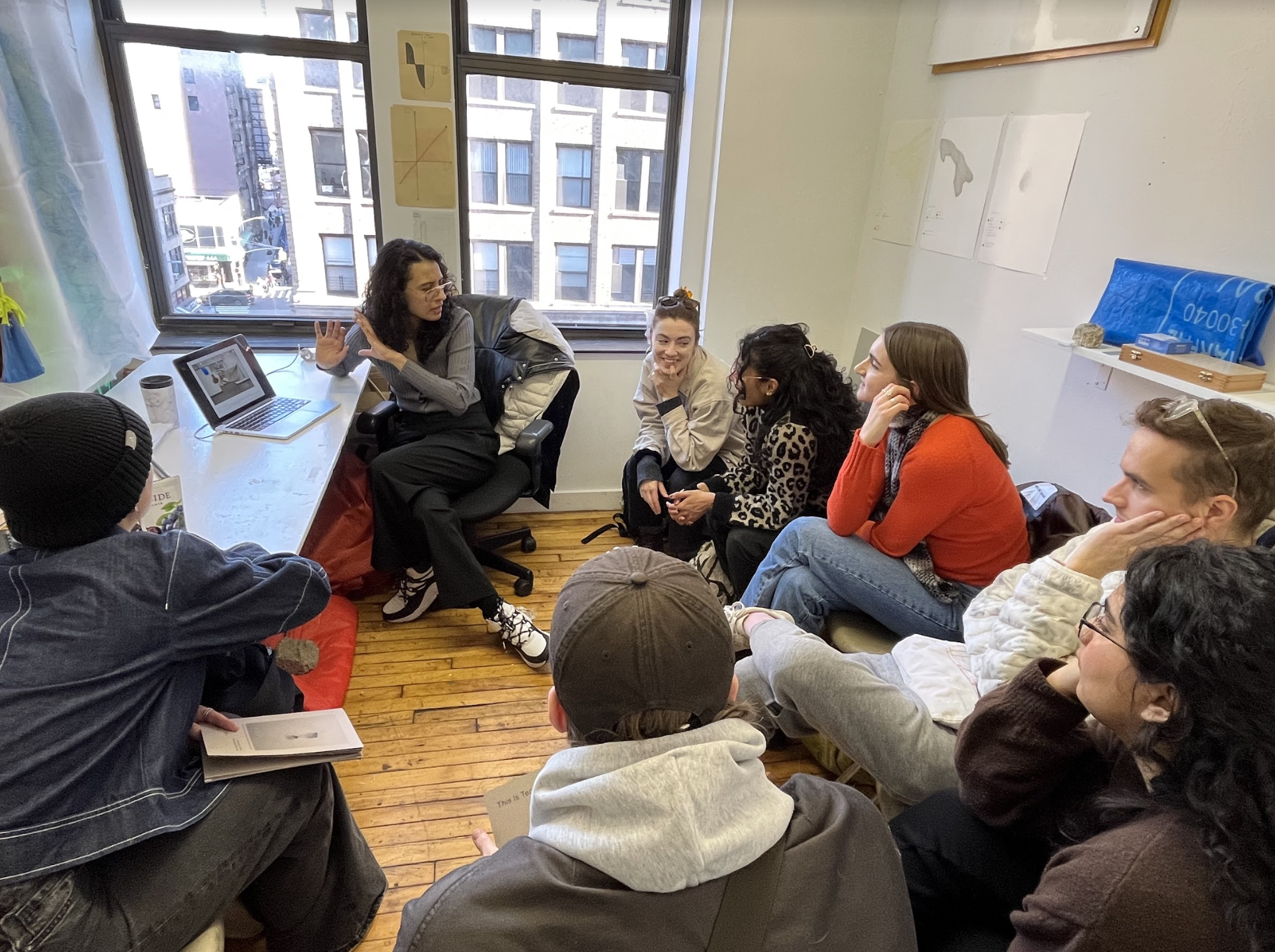 students speaking with teacher in classroom