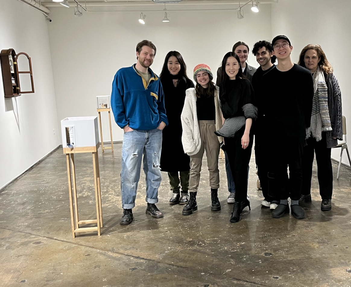students speaking with teacher in classroom
