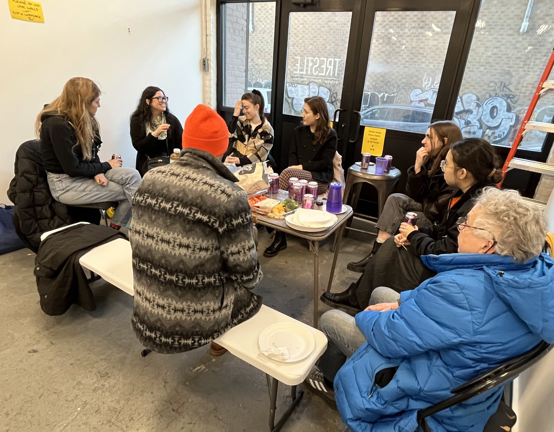 students speaking with teacher in classroom