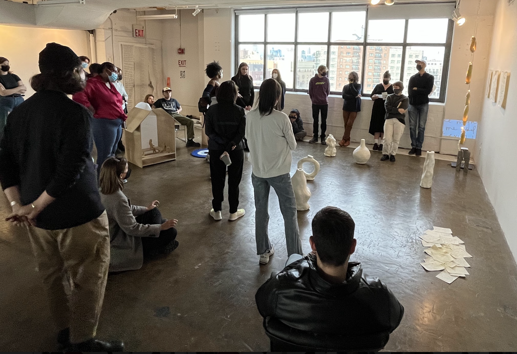 students speaking with teacher in classroom