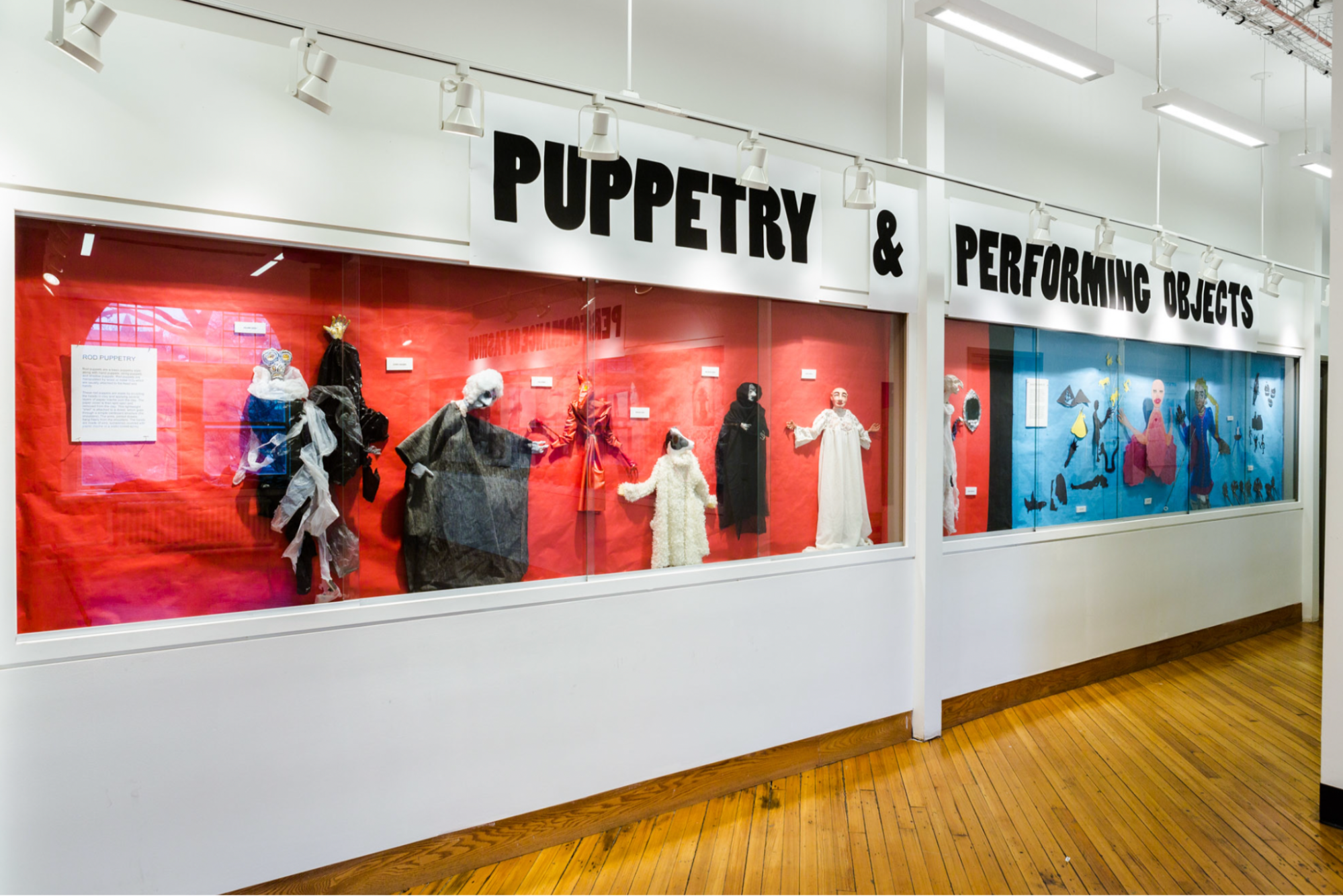 view of gallery exhibition, behind glass, the words 