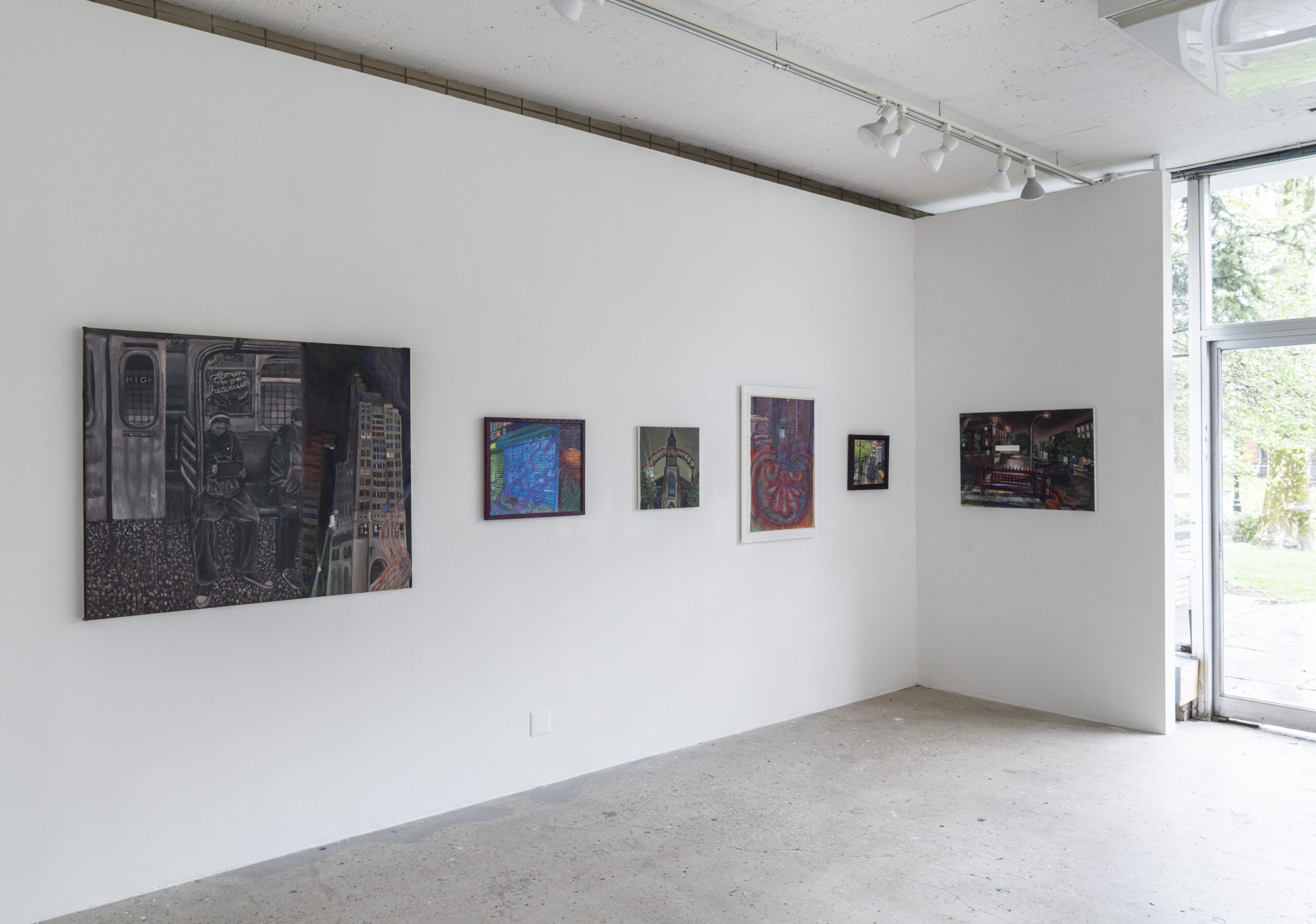 A bright, contemporary gallery showcasing a collection of whimsical and surreal paintings. The artworks feature playful subjects, including a cat portrait, a sunflower-faced figure, and dreamlike characters. A small wooden table in the corner holds decorative objects, enhancing the exhibition’s intimate, nostalgic atmosphere. The room is illuminated by natural light, emphasizing the vibrant colors and intricate details.