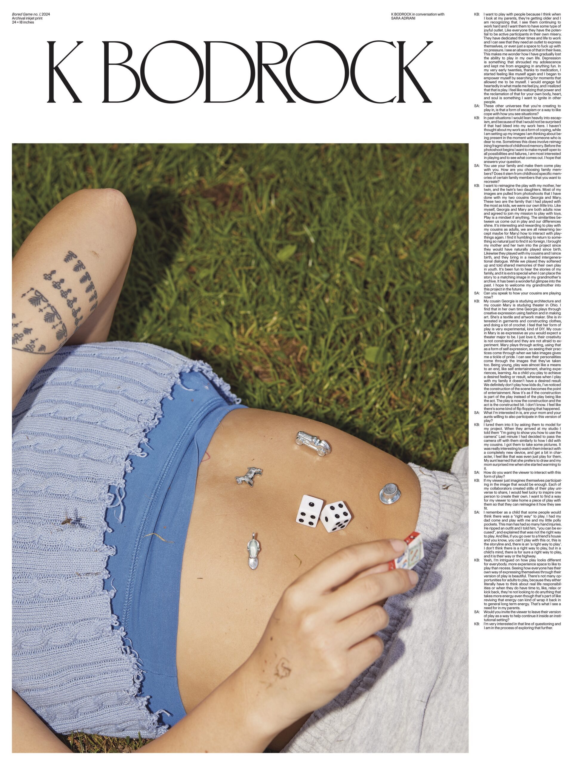 Poster showcasing K Bodrock’s work for the Pratt MFA Thesis 2025. A close-up photograph of a person lying on grass with their midriff exposed. The subject wears a blue knit crop top and holds a small die in their hand. Various game pieces and dice are scattered across their stomach. A tattoo of repeating leaf-like symbols is visible on the subject’s arm. The artist's name appears above in serif font, and an interview with Sara Aranoff is shown in columns to the right.