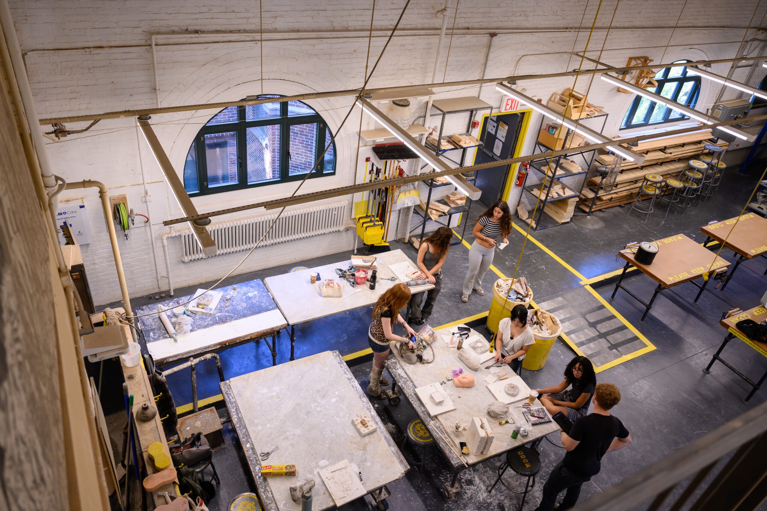 Upper level view of students working in the Fine Arts woodshop