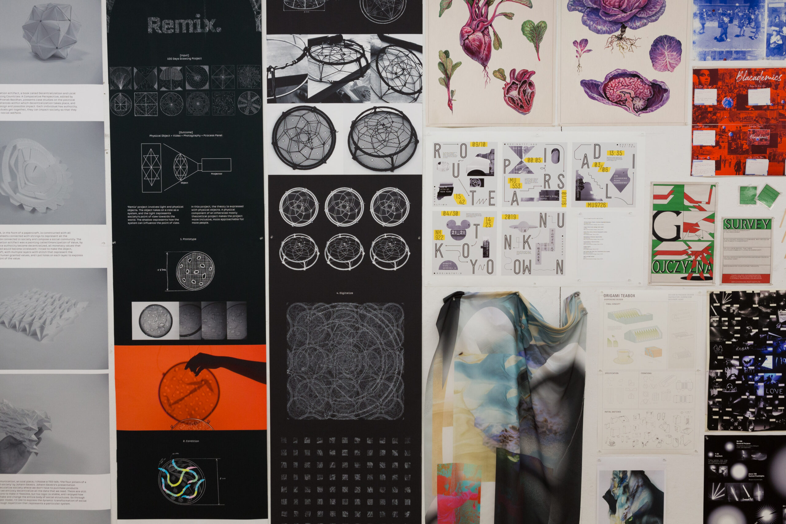 A collage of various design sketches hang from a wall. The designs range from wireframes and graphics to anatomy drawings and abstract 3d shapes.