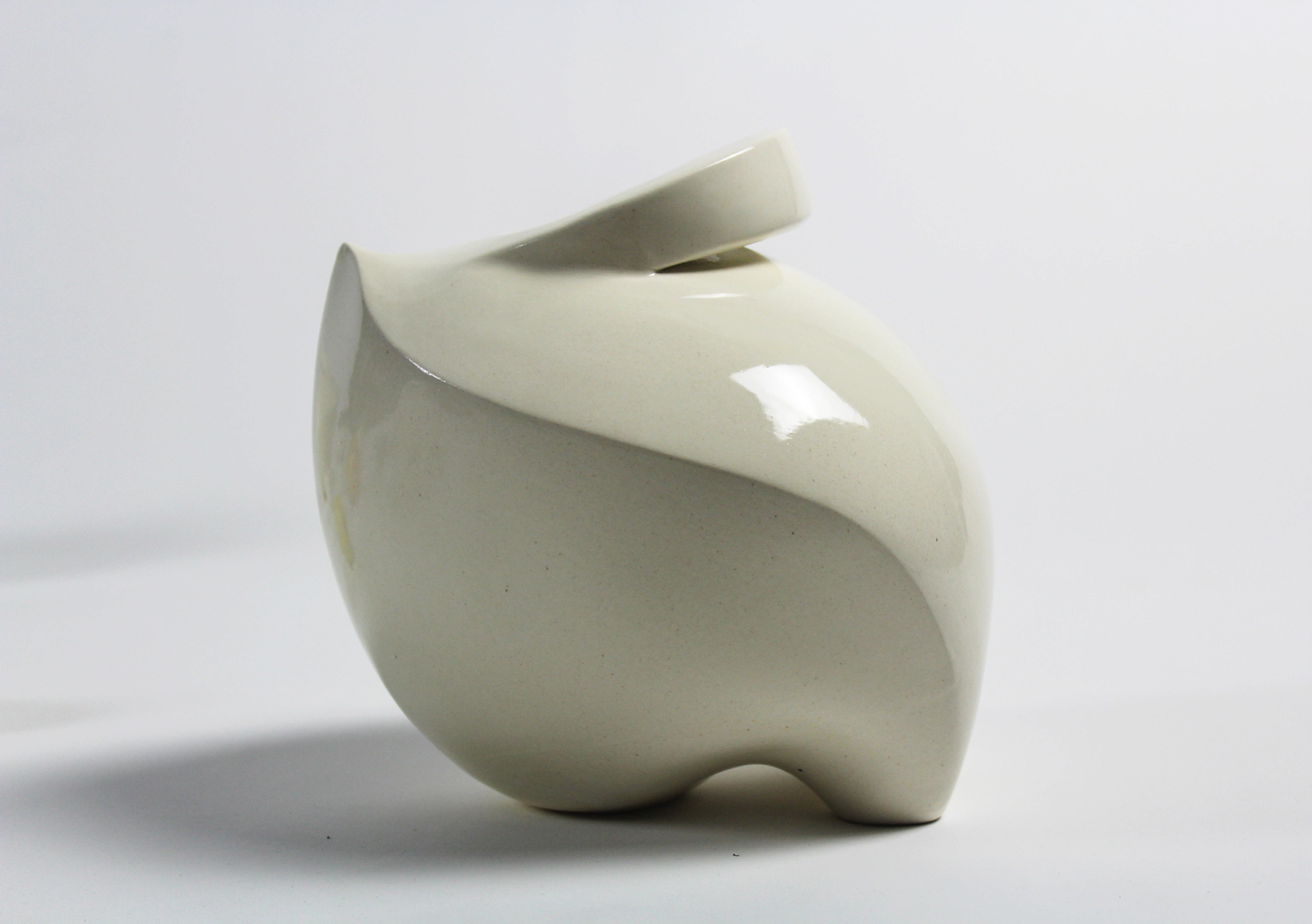 a white ceramic pot with a glossy glaze