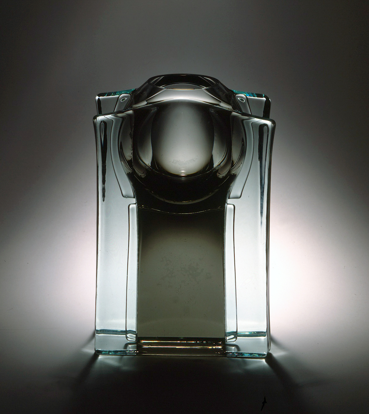 a sculpture made of glass planes surrounding a spherical core