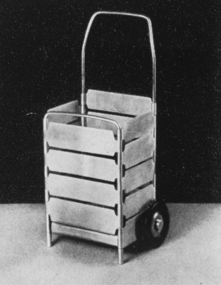 a black and white photograph of a cart with wheels