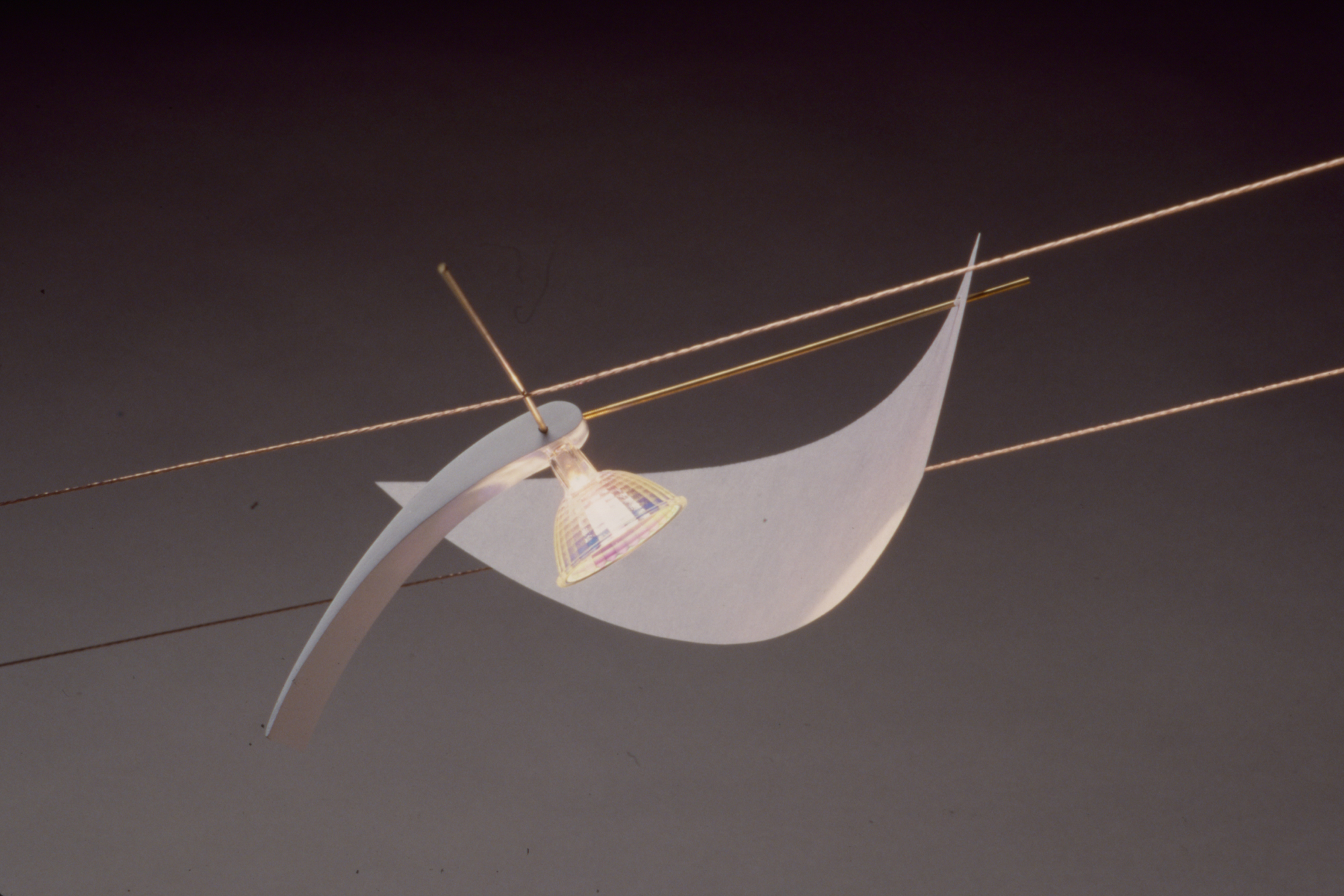 a light fixture composed of wires and curved planes