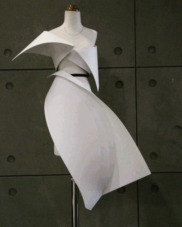 a dress made of curved white planes seen on a dress form