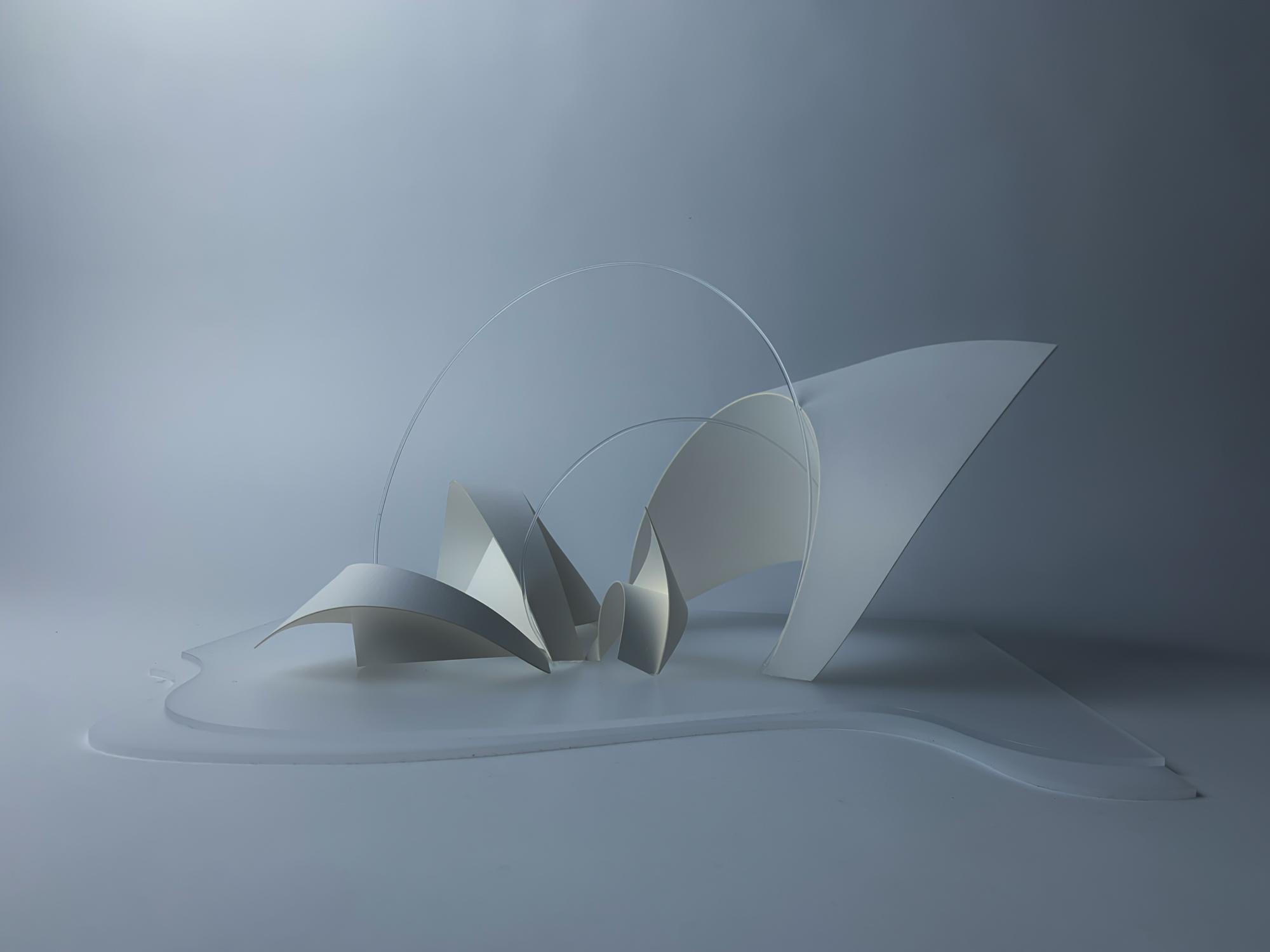 a model of a temple composed of curved white planes