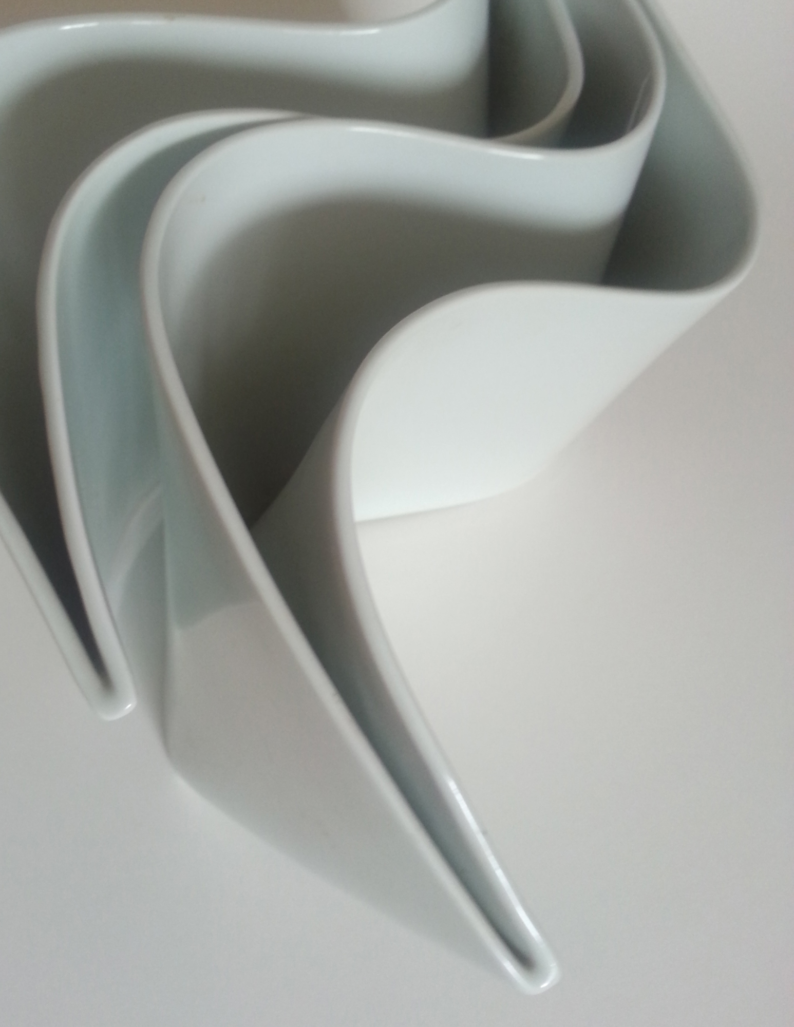 close-up of a vase made of curved white planes
