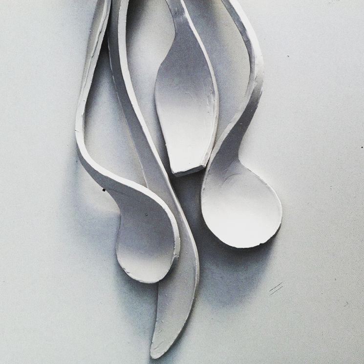 a detail photograph of four clay spoons
