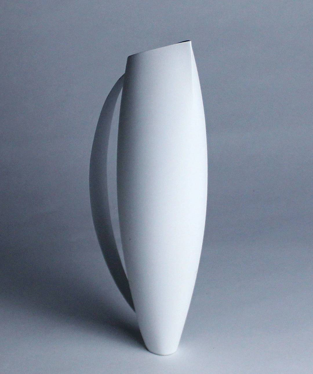 a tall vase made of one rolled white plane