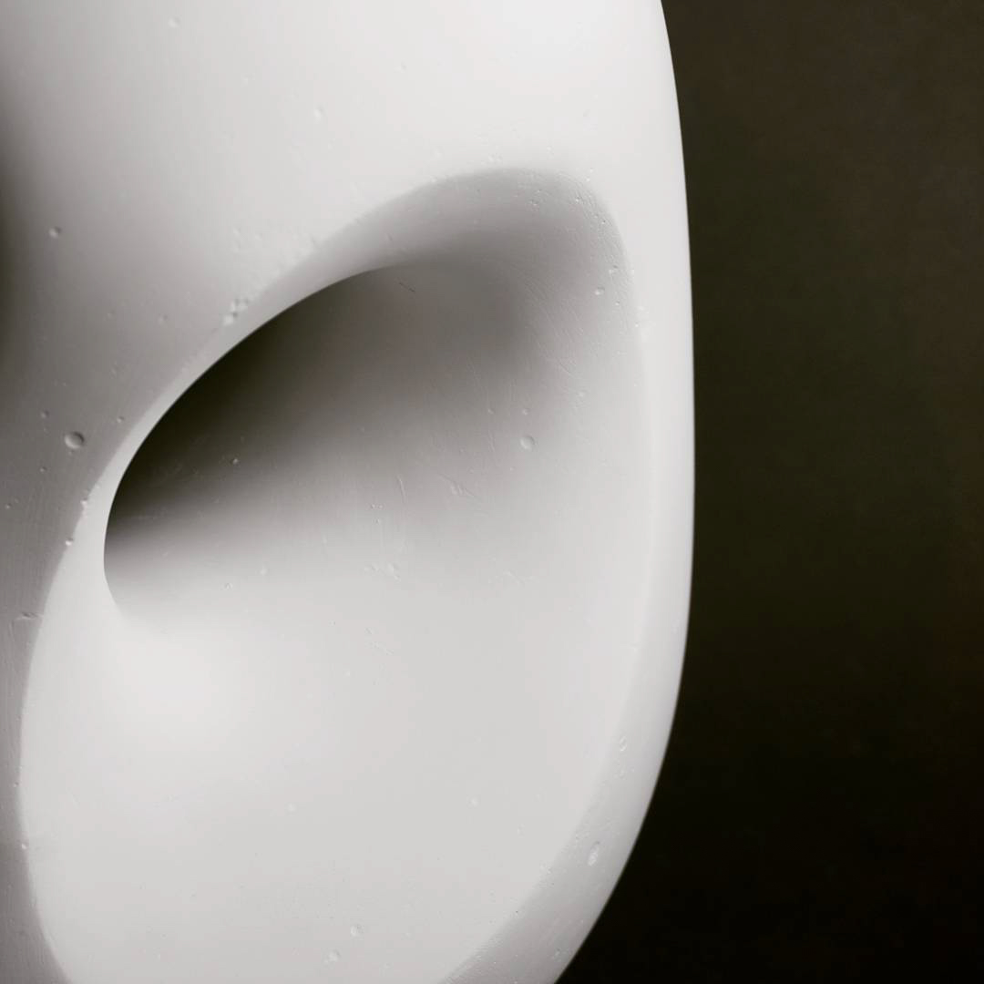 a detail photograph of a circular hole in a white form