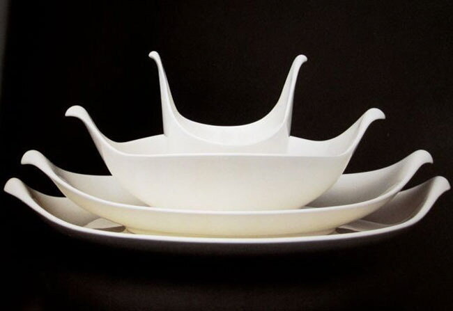 four stacked white bowls with tapered handles of increasing width that resemble a splash when put together