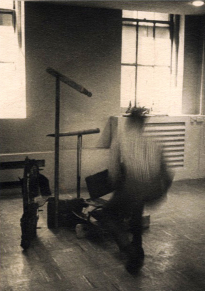 a blurred black and white photograph of a figure in a classroom