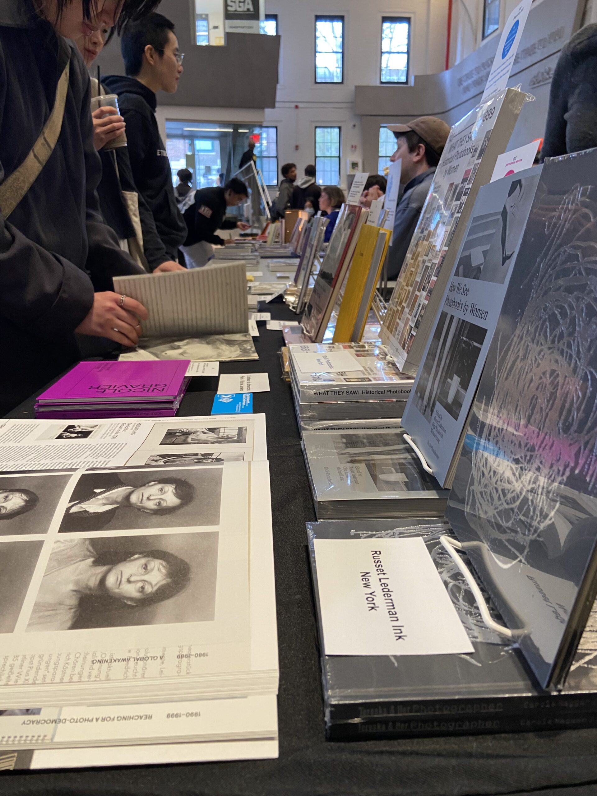 People looking at books in student union