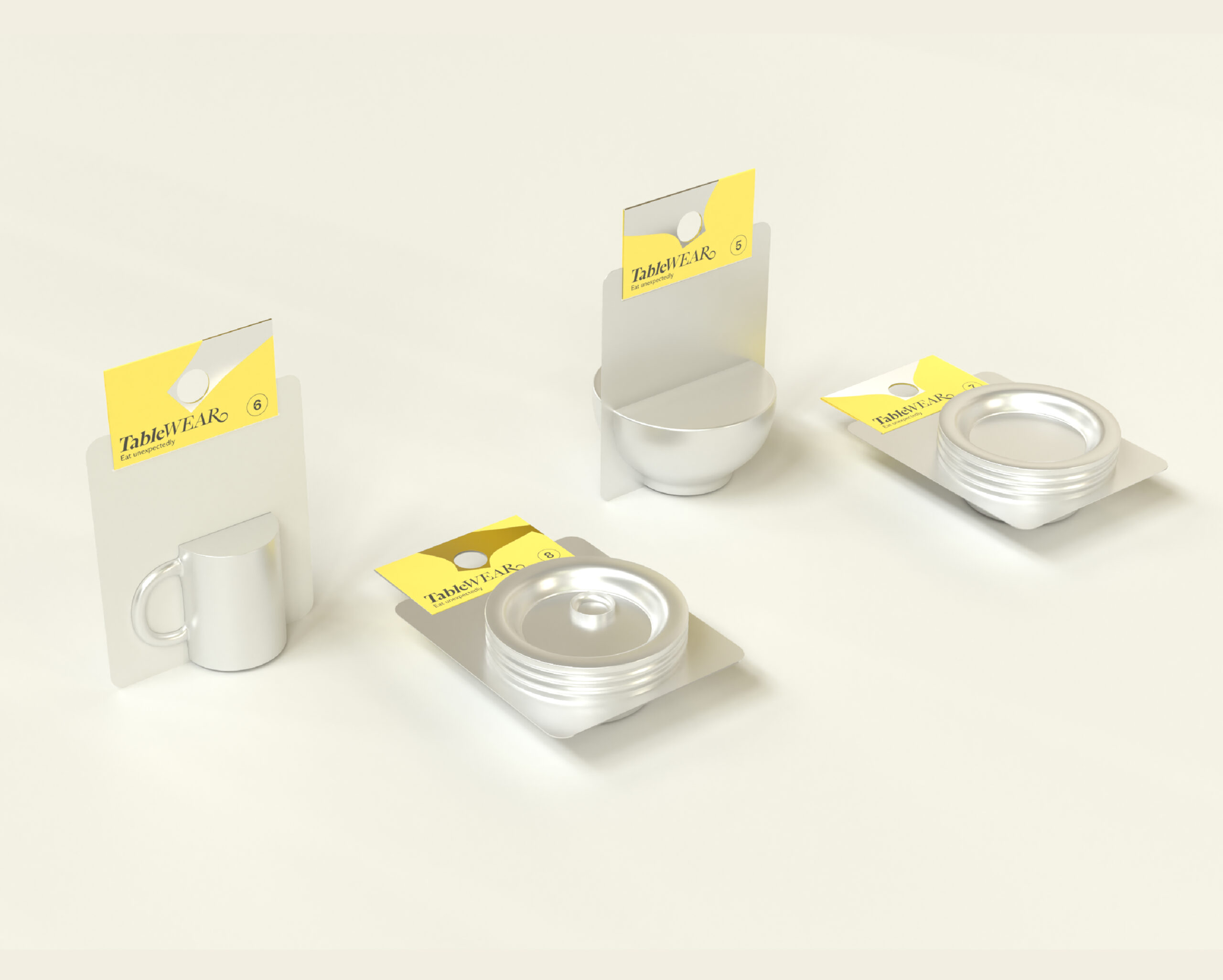 Four metallic tableware items are displayed in minimalist packaging on a light background. The items include a small mug, a bowl, and two circular containers, all with yellow tags labeled "TableWEAR." Each item is designed with a sleek, modern aesthetic. The packaging has a simple design, emphasizing the product.