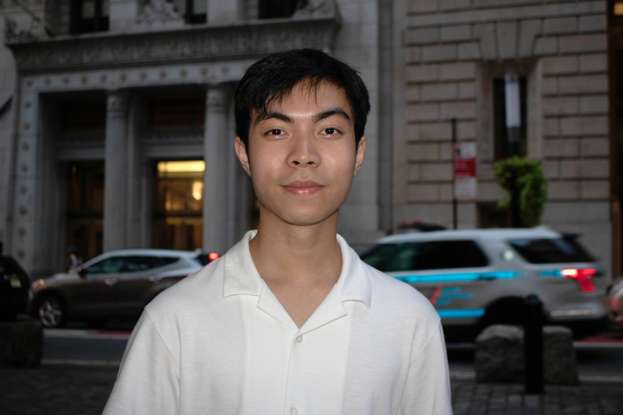 Alumnus Jonathan Lin stands on a city street in New York City.